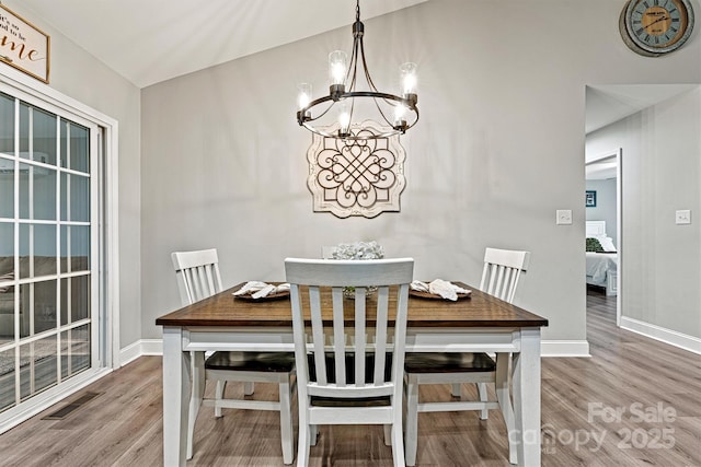 3615 Kimber Ln, Sherrills Ford, NC 28673 - dining space with baseboards, visible vents, wood finished floors, and a notable chandelier