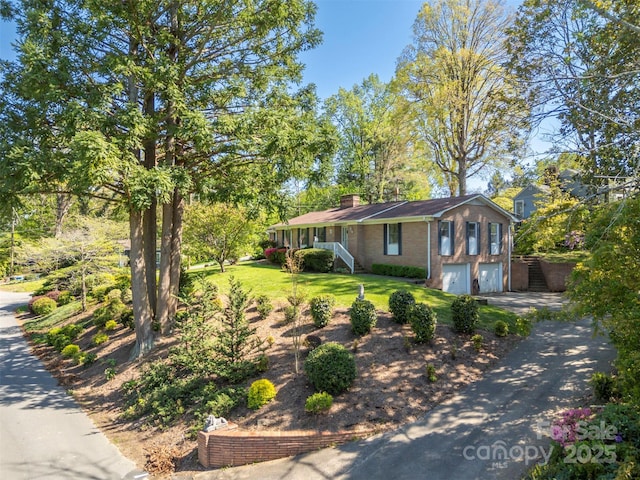 151 Fernwood Dr, Rutherfordton, NC 28139 - view of front of property with a garage, brick siding, asphalt driveway, a front yard, and a chimney