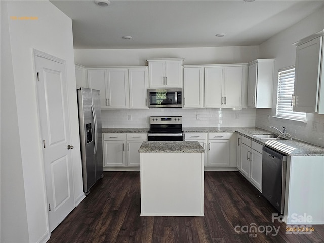 106 Calderdale Ln, Charlotte, NC 28262 - kitchen featuring backsplash, stainless steel appliances, a sink, and a center island