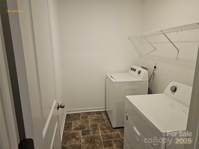 106 Calderdale Ln, Charlotte, NC 28262 - laundry area featuring washing machine and clothes dryer, laundry area, stone finish flooring, and baseboards