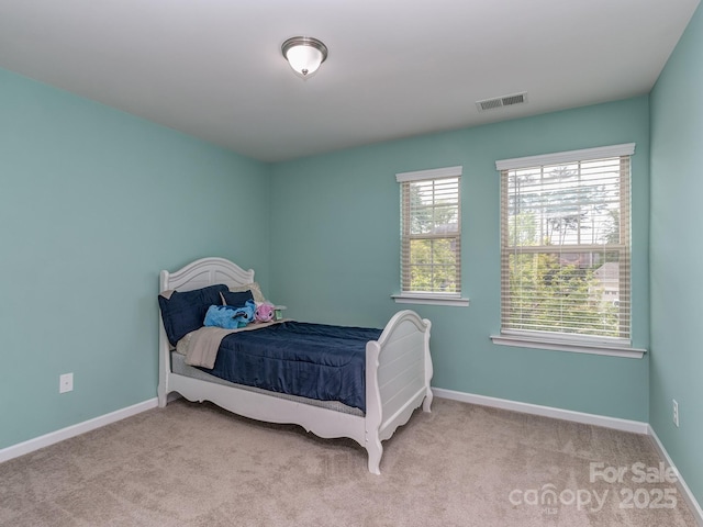 carpeted bedroom with baseboards and visible vents