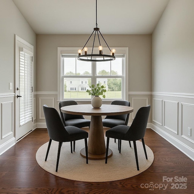 4926 Trayton Ave, Gastonia, NC 28056 - dining space featuring wainscoting, plenty of natural light, dark wood-type flooring, and a notable chandelier