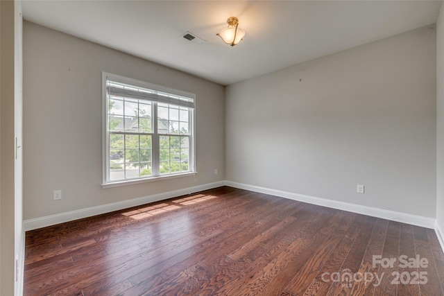 4926 Trayton Ave, Gastonia, NC 28056 - empty room with dark wood-style flooring, baseboards, and visible vents