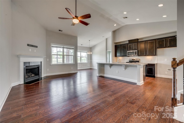 4926 Trayton Ave, Gastonia, NC 28056 - kitchen featuring appliances with stainless steel finishes, high vaulted ceiling, a ceiling fan, open floor plan, and dark wood-type flooring