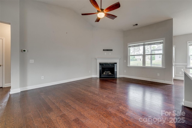 4926 Trayton Ave, Gastonia, NC 28056 - unfurnished living room featuring ceiling fan, visible vents, a fireplace with flush hearth, and wood finished floors