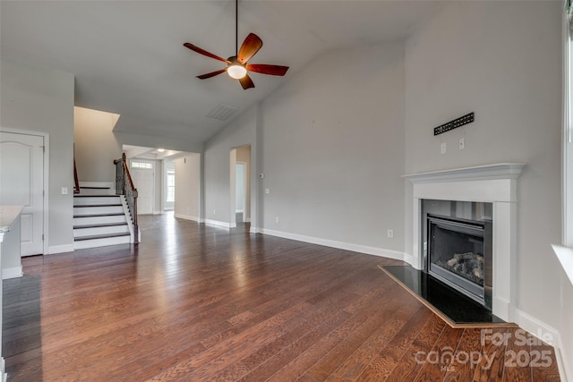 4926 Trayton Ave, Gastonia, NC 28056 - unfurnished living room with visible vents, dark wood-style flooring, a fireplace, ceiling fan, and stairway