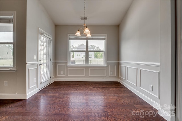 4926 Trayton Ave, Gastonia, NC 28056 - unfurnished dining area featuring a chandelier, visible vents, dark wood finished floors, and a decorative wall