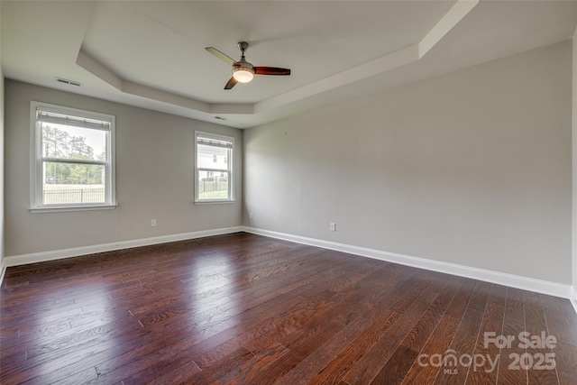 4926 Trayton Ave, Gastonia, NC 28056 - empty room featuring a raised ceiling, ceiling fan, dark wood finished floors, and visible vents