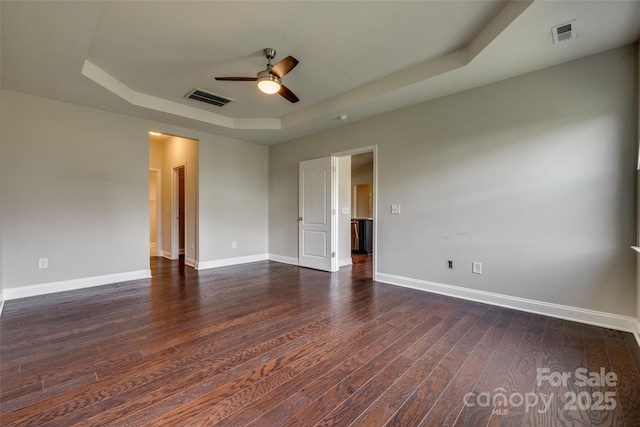 4926 Trayton Ave, Gastonia, NC 28056 - unfurnished room with a ceiling fan, a tray ceiling, dark wood-style floors, and visible vents