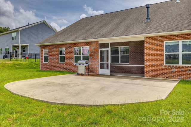 4926 Trayton Ave, Gastonia, NC 28056 - back of house with fence, roof with shingles, brick siding, a patio, and a yard