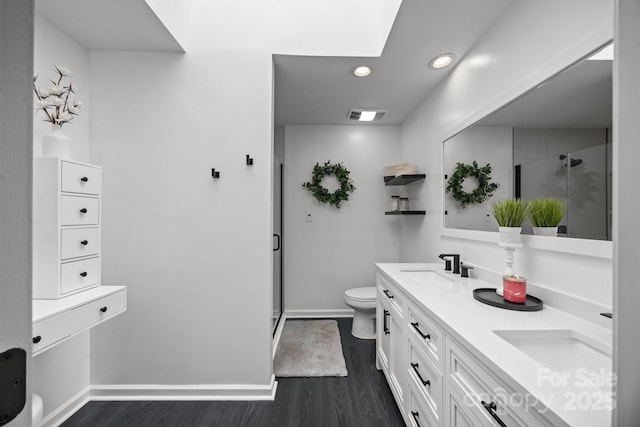 bathroom with visible vents, wood finished floors, toilet, recessed lighting, and a shower stall
