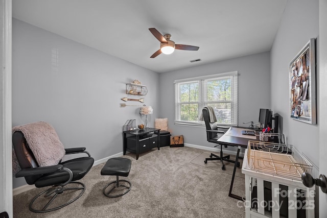 carpeted office space with ceiling fan, visible vents, and baseboards