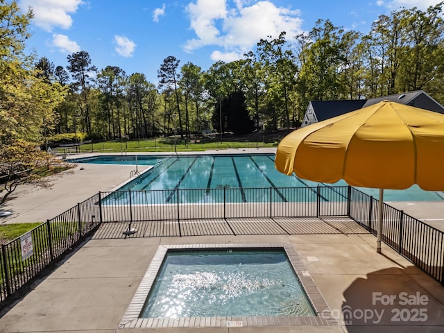 community pool featuring a patio area and fence