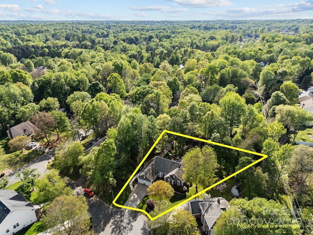 birds eye view of property with a view of trees