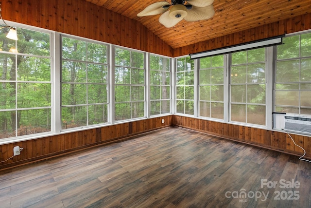 unfurnished sunroom with vaulted ceiling, ceiling fan, and wooden walls