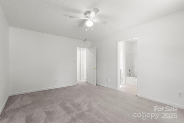 318 Huffman Rd, Gastonia, NC 28056 - unfurnished bedroom with carpet flooring, baseboards, ensuite bathroom, and ceiling fan