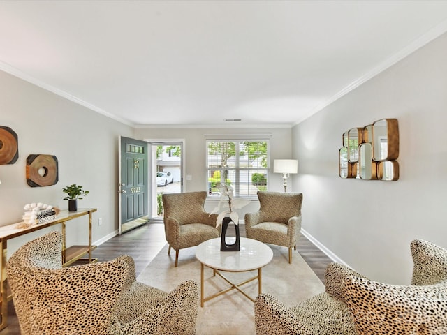 living room with baseboards, wood finished floors, and crown molding