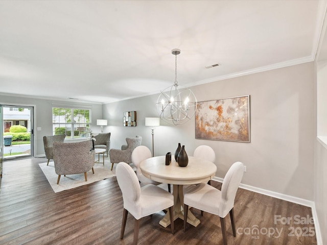 dining space with a chandelier, dark wood-style flooring, ornamental molding, and baseboards