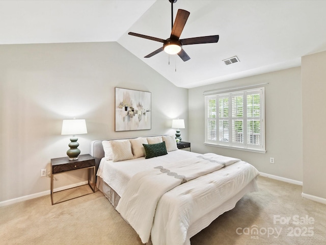 bedroom with light colored carpet, vaulted ceiling, baseboards, and ceiling fan