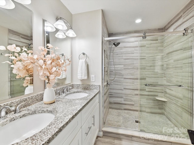 full bathroom with a shower stall, recessed lighting, and double vanity