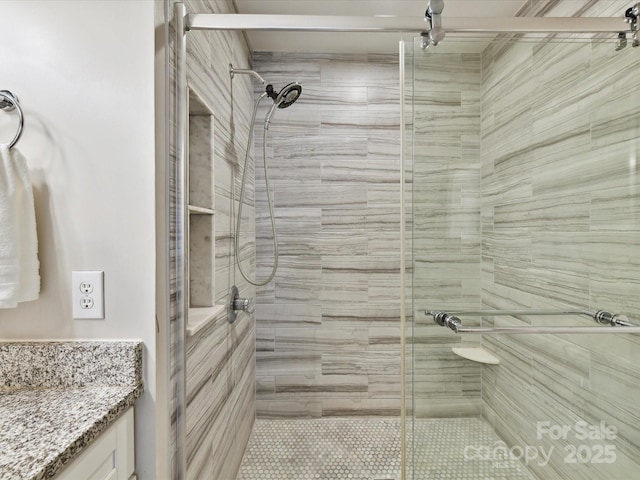 full bath featuring a shower stall and vanity