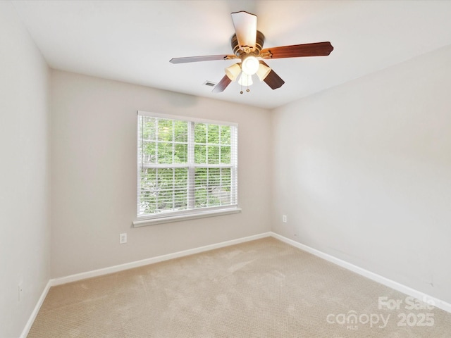 unfurnished room featuring light colored carpet, baseboards, and ceiling fan