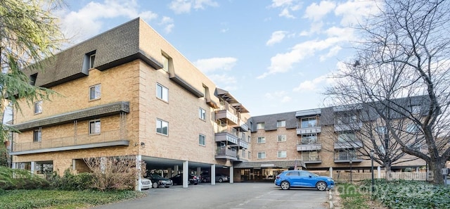 1323 Queens Rd Unit 420, Charlotte, NC 28207 - view of property featuring covered and uncovered parking