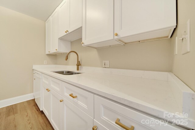 1323 Queens Rd Unit 420, Charlotte, NC 28207 - kitchen featuring white cabinetry, a sink, baseboards, dishwasher, and light wood finished floors