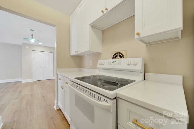 1323 Queens Rd Unit 420, Charlotte, NC 28207 - kitchen with white cabinetry, electric stove, and light wood-style flooring