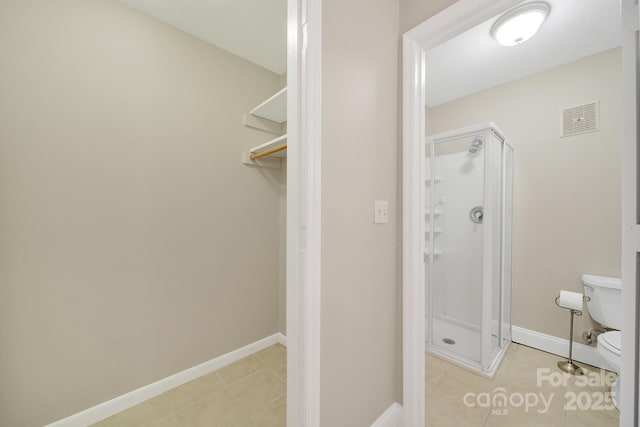 1323 Queens Rd Unit 420, Charlotte, NC 28207 - full bath featuring visible vents, toilet, tile patterned flooring, and a stall shower