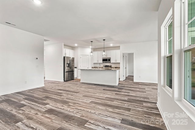 3567 Farmfield Dr, Claremont, NC 28610 - unfurnished living room with visible vents, a sink, baseboards, recessed lighting, and dark wood-type flooring