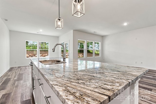 3567 Farmfield Dr, Claremont, NC 28610 - kitchen with wood finished floors, recessed lighting, white cabinets, a sink, and decorative light fixtures