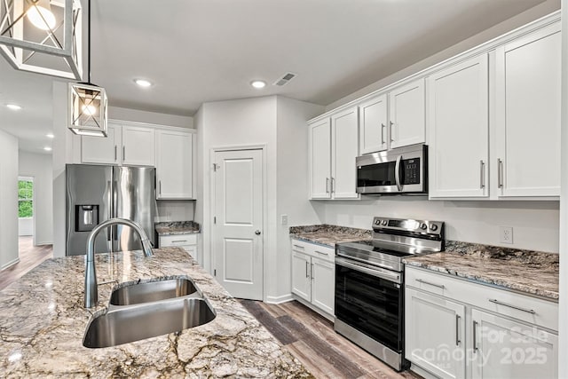 3567 Farmfield Dr, Claremont, NC 28610 - kitchen with a sink, white cabinetry, appliances with stainless steel finishes, and dark wood-style floors