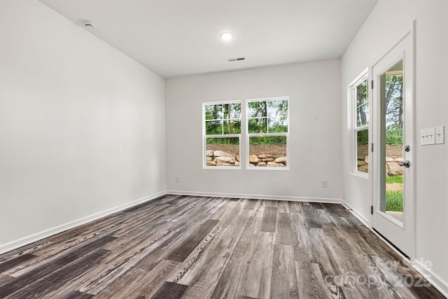 3567 Farmfield Dr, Claremont, NC 28610 - empty room featuring baseboards, plenty of natural light, dark wood-style floors, and visible vents