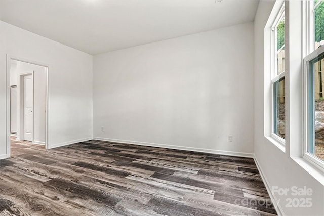 3567 Farmfield Dr, Claremont, NC 28610 - empty room featuring baseboards, dark wood finished floors, and plenty of natural light