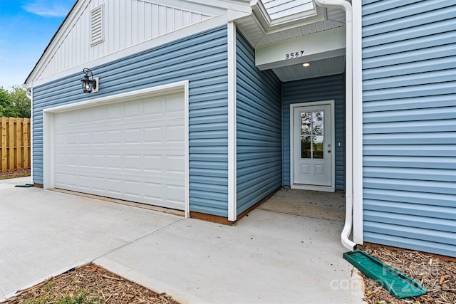 3567 Farmfield Dr, Claremont, NC 28610 - doorway to property with a garage, board and batten siding, fence, and driveway