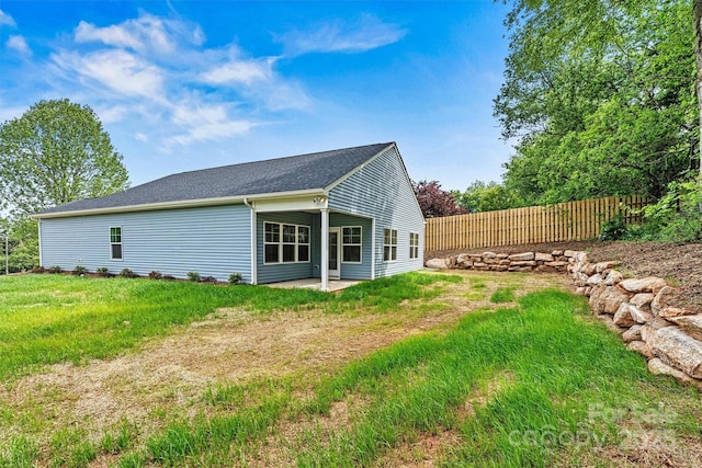 3567 Farmfield Dr, Claremont, NC 28610 - back of house with fence, a lawn, a patio area, and roof with shingles