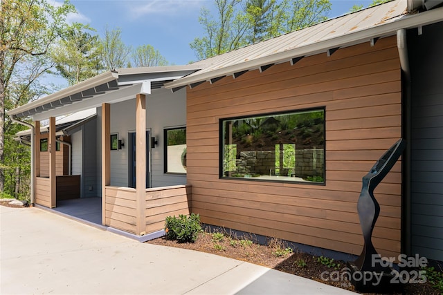 view of side of home featuring metal roof