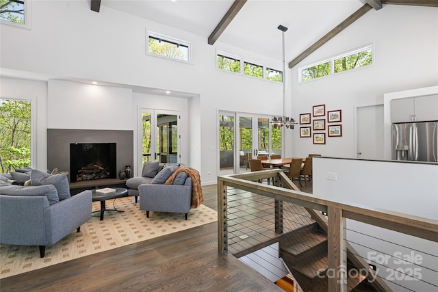 living room with dark wood-type flooring, high vaulted ceiling, and beamed ceiling