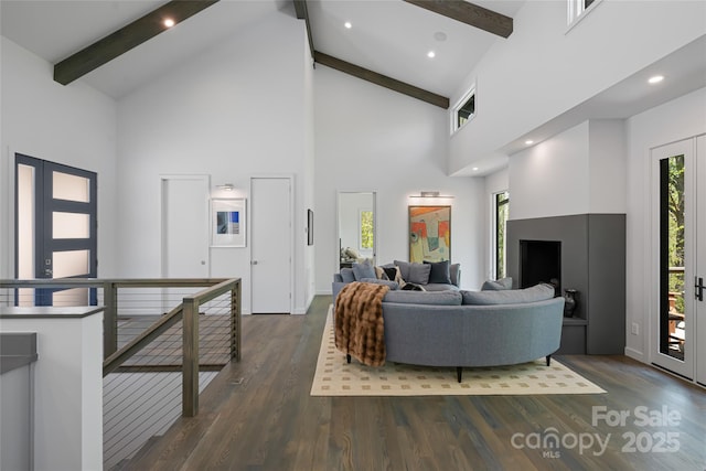 living room with beamed ceiling, dark wood-style flooring, high vaulted ceiling, and plenty of natural light