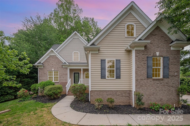 1033 Marguerite Dr, Lowell, NC 28098 - view of front facade with covered porch and brick siding