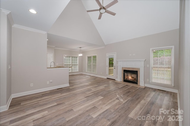 1033 Marguerite Dr, Lowell, NC 28098 - unfurnished living room with a fireplace, high vaulted ceiling, ceiling fan with notable chandelier, baseboards, and wood finished floors
