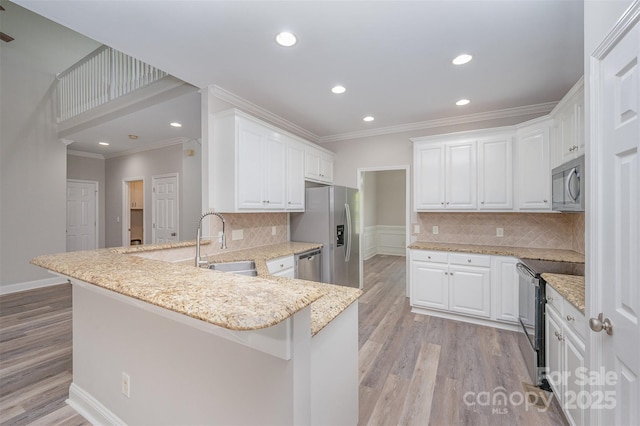 1033 Marguerite Dr, Lowell, NC 28098 - kitchen with a sink, ornamental molding, stainless steel appliances, and a peninsula