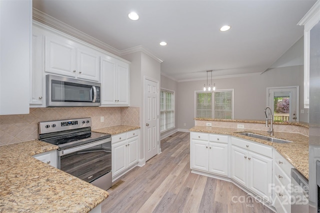 1033 Marguerite Dr, Lowell, NC 28098 - kitchen featuring crown molding, white cabinetry, a sink, appliances with stainless steel finishes, and backsplash