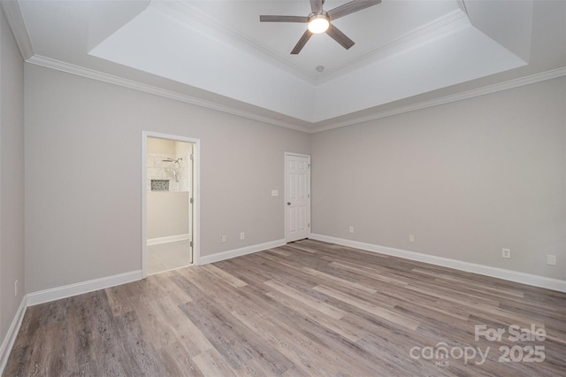 1033 Marguerite Dr, Lowell, NC 28098 - empty room featuring ornamental molding, wood finished floors, baseboards, ceiling fan, and a raised ceiling