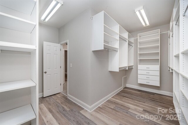 1033 Marguerite Dr, Lowell, NC 28098 - spacious closet featuring wood finished floors