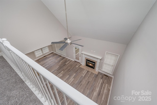 1033 Marguerite Dr, Lowell, NC 28098 - unfurnished living room with a high end fireplace, high vaulted ceiling, a ceiling fan, and wood finished floors
