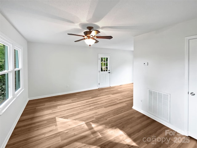 269 Bud Black Rd, Crouse, NC 28033 - spare room with wood finished floors, visible vents, baseboards, and ceiling fan