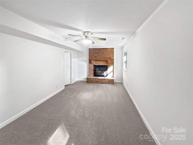 269 Bud Black Rd, Crouse, NC 28033 - unfurnished living room with carpet flooring, baseboards, a ceiling fan, a brick fireplace, and crown molding