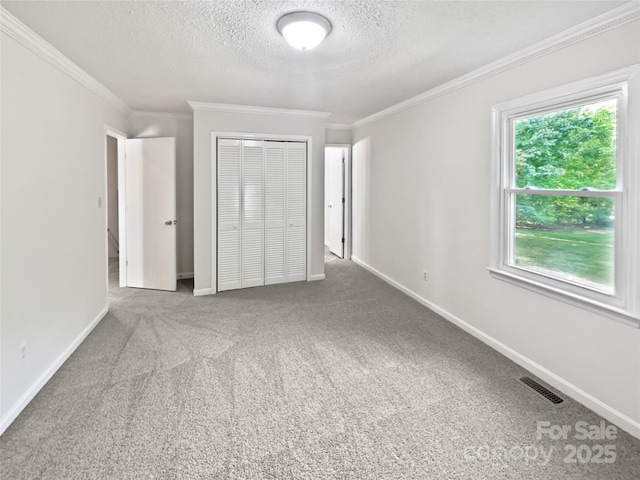 269 Bud Black Rd, Crouse, NC 28033 - unfurnished bedroom with crown molding, a textured ceiling, a closet, carpet floors, and visible vents